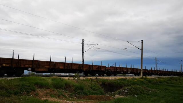 BDZ Freight Train with empty platforms heading to Iskar Train Station in Bulgaria